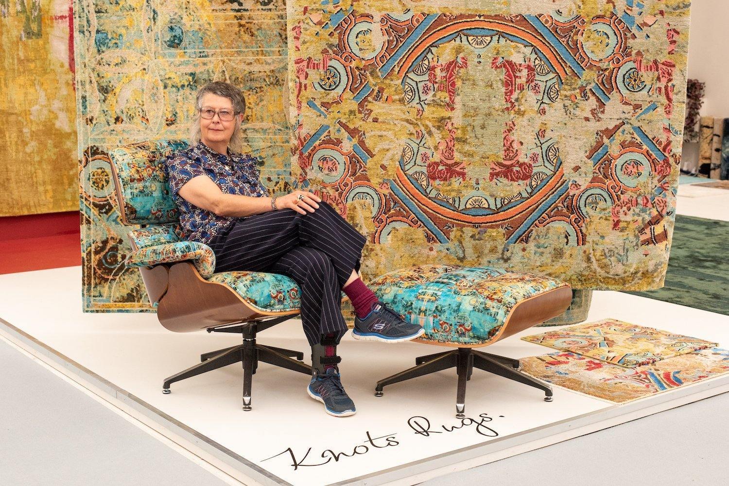 Artist Maxine Hall sits beside the Knots Rugs contemporary art rug